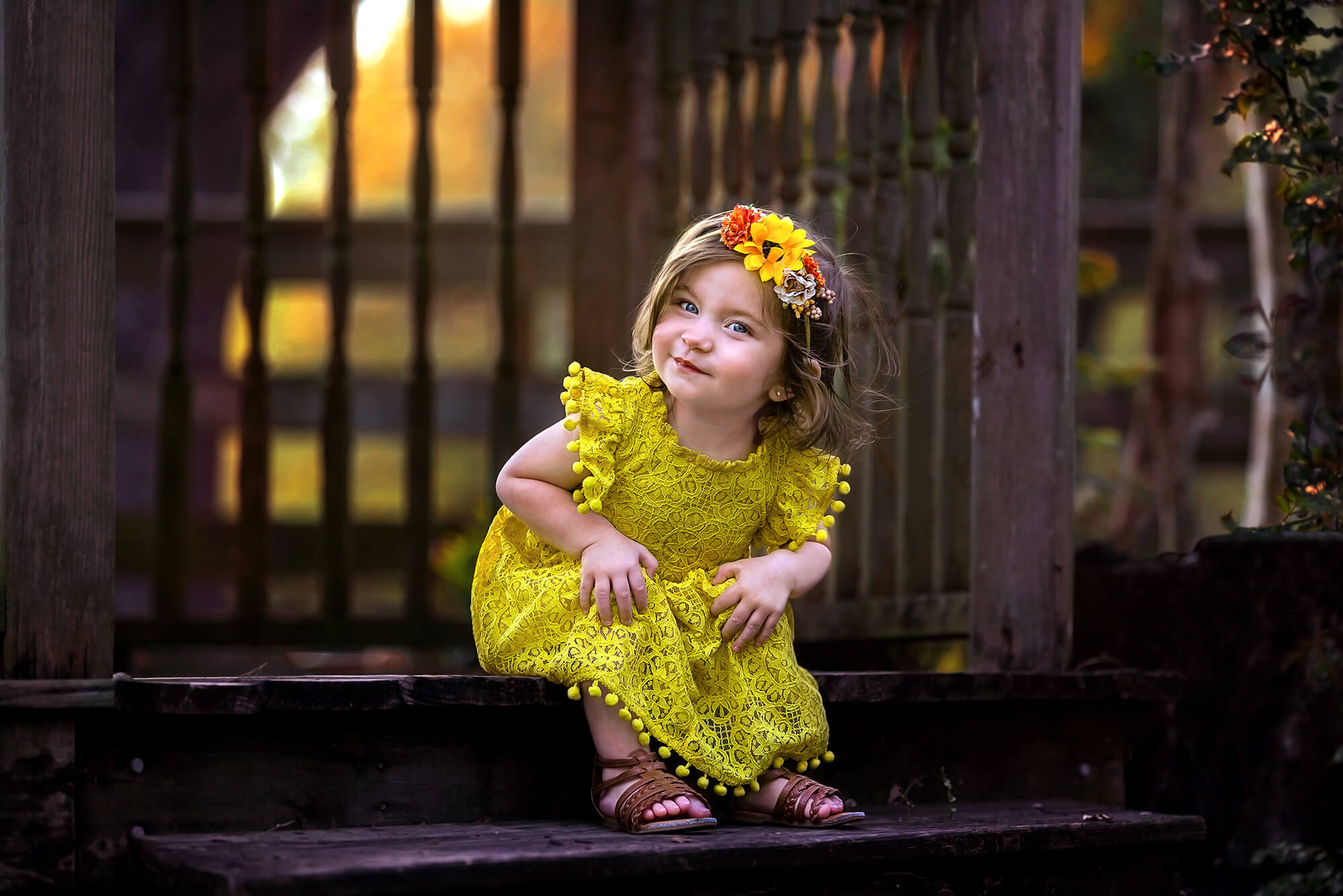 Cute toddler wearing a yellow dress bought on one of the Houston baby stores