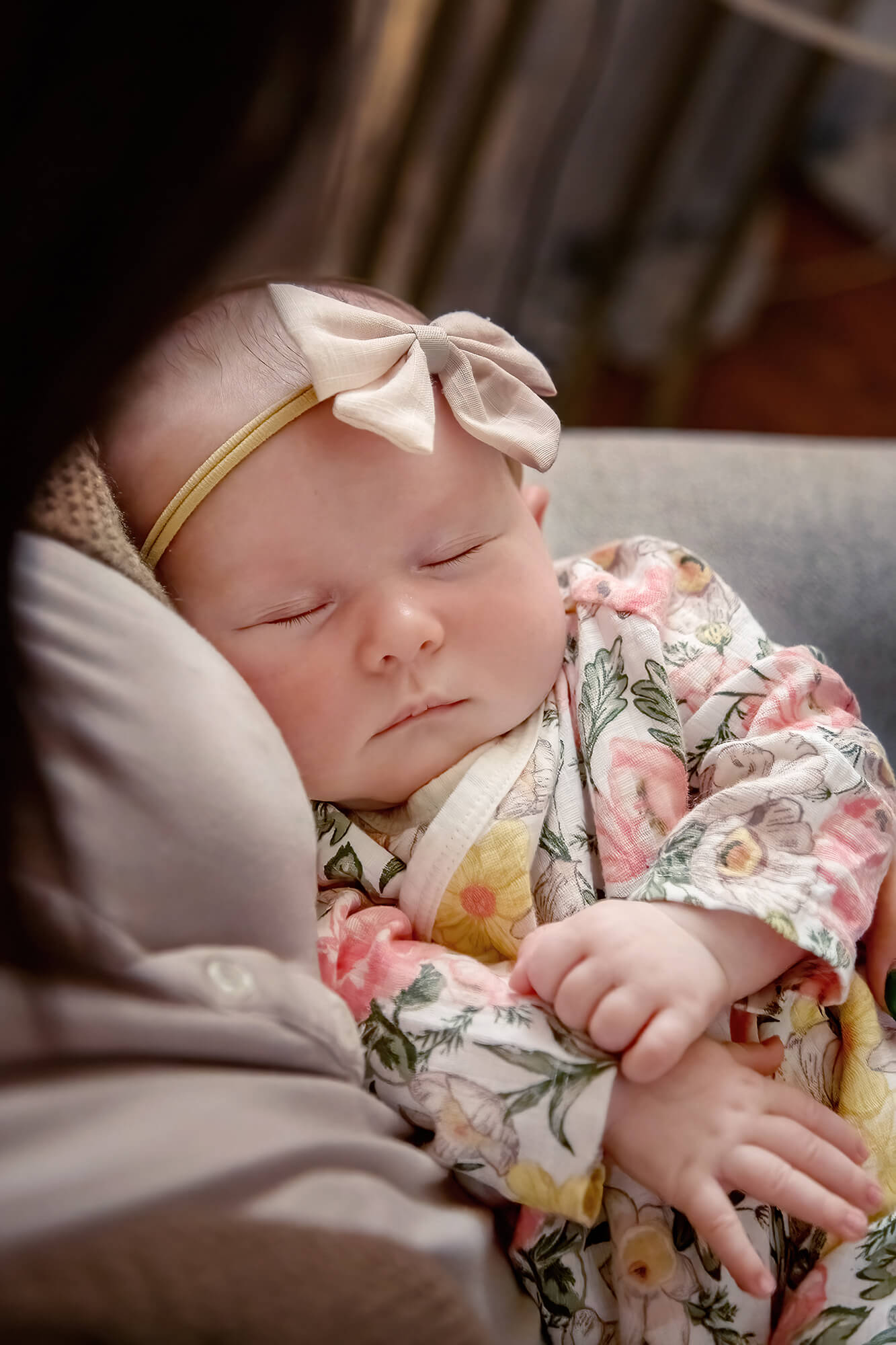 Adorable newborn baby girl in her mom's arms