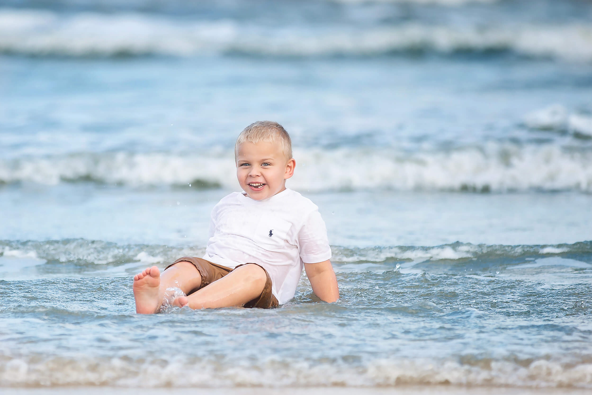 Young boy having fun at the beach during the summer near Houston, Texas.