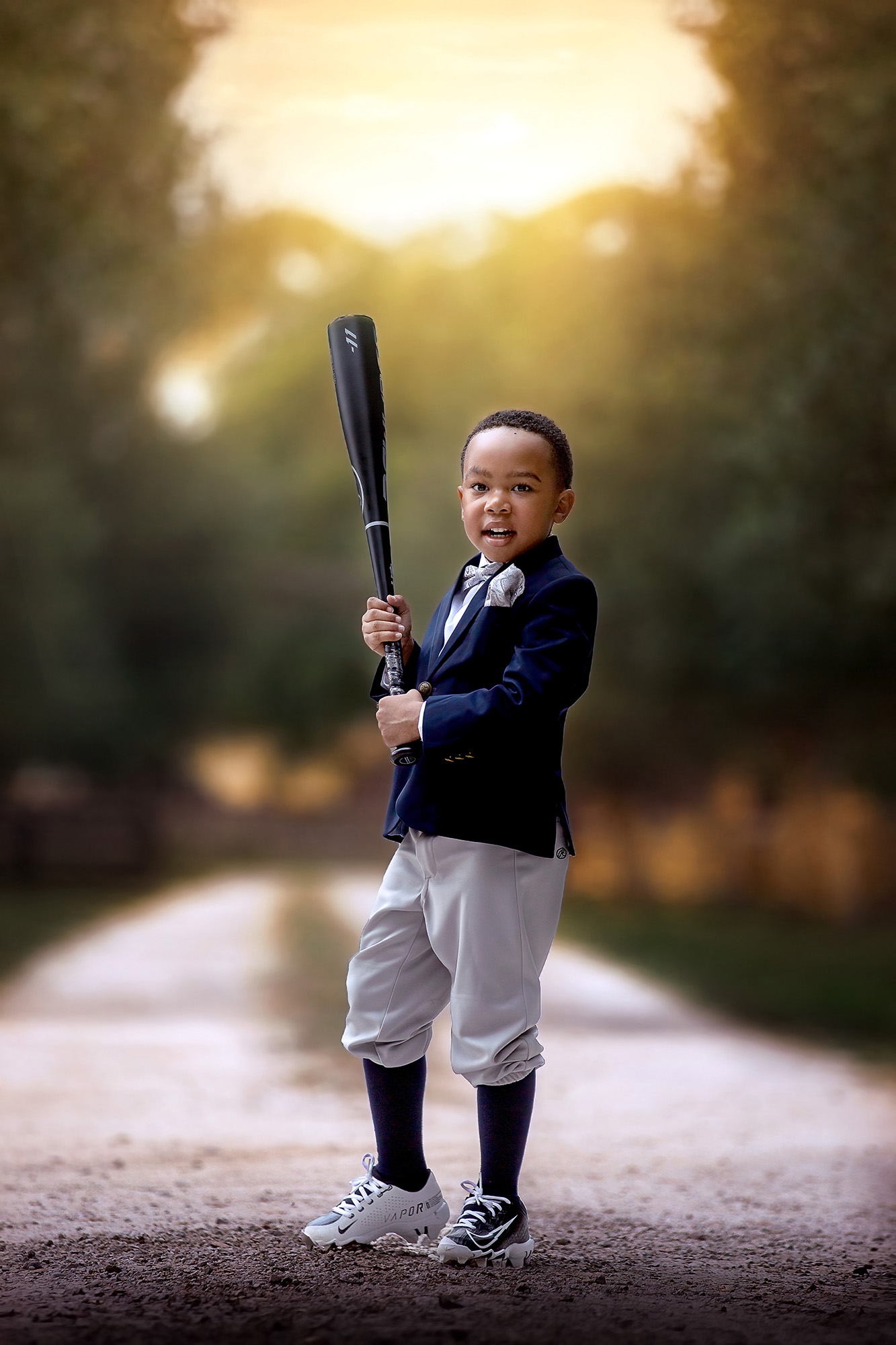 Adorable and stylish little boy dressed in a suit and sports clothes with his baseball gear going to one of the indoor playgrounds in Houston.