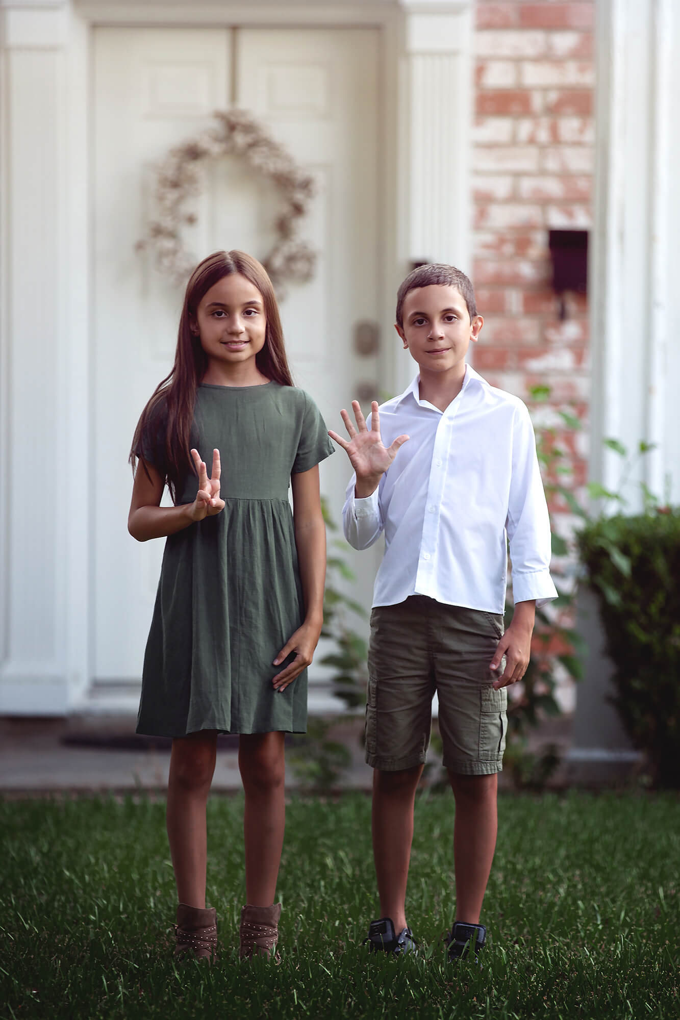 Siblings showing their grades on their first day of school in Houston.