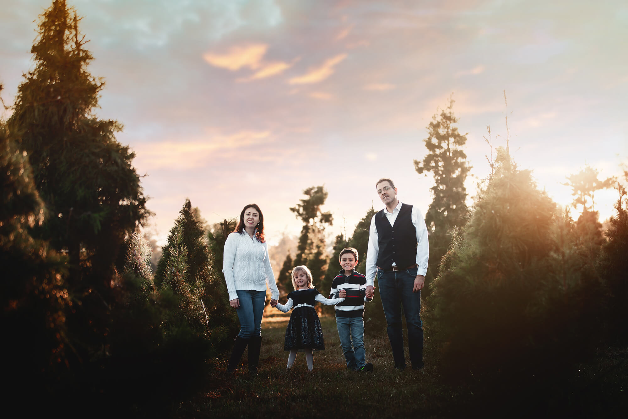 Family of four during sunset on a tree farm in Houston, Texas.
