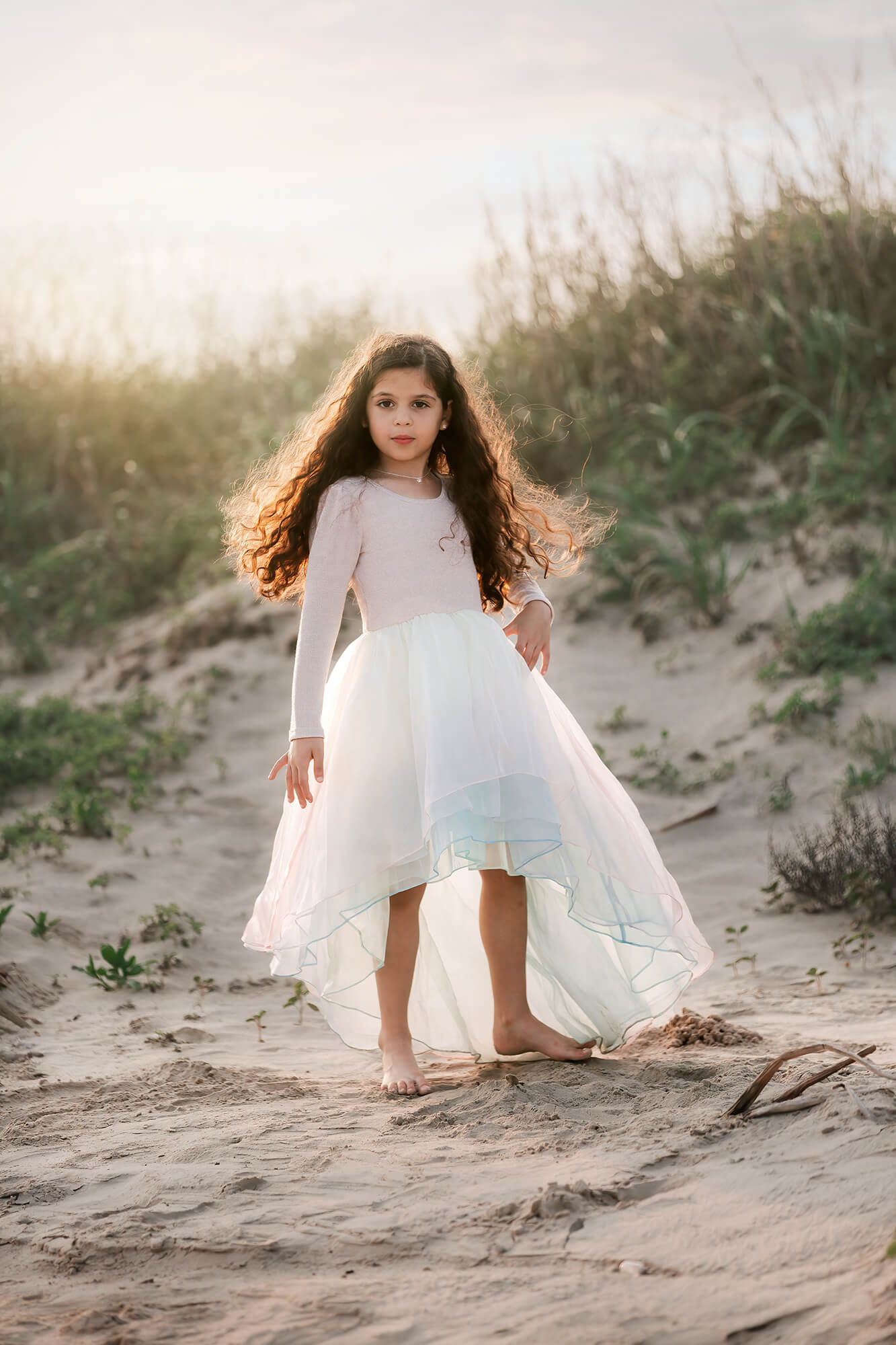 Beautiful girl wearing a fancy dress at the beach edited using Kyle Goldie's presets for portraits.