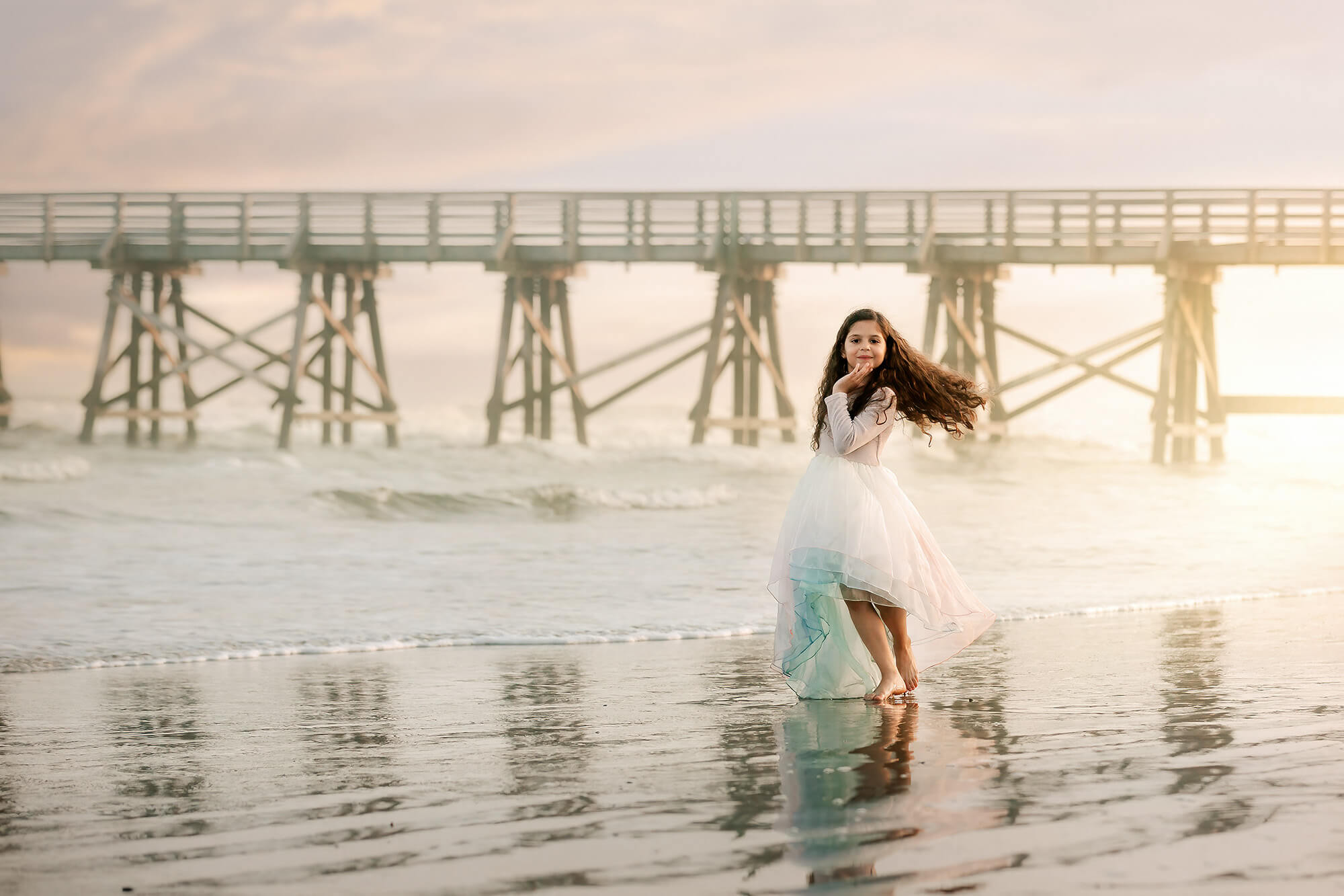 Beautiful girl twirling at the beach at golden hour edited using Kyle Goldie's presets for portraits.