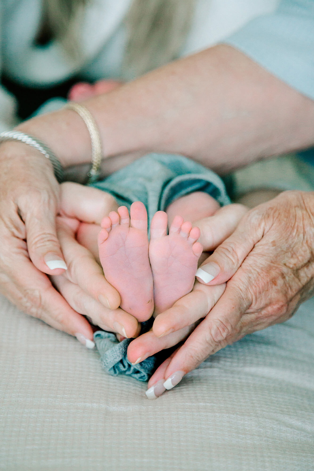 Parents hold their baby feet in the shape of a heart during their visit with their favorite Houston lactation consultant.