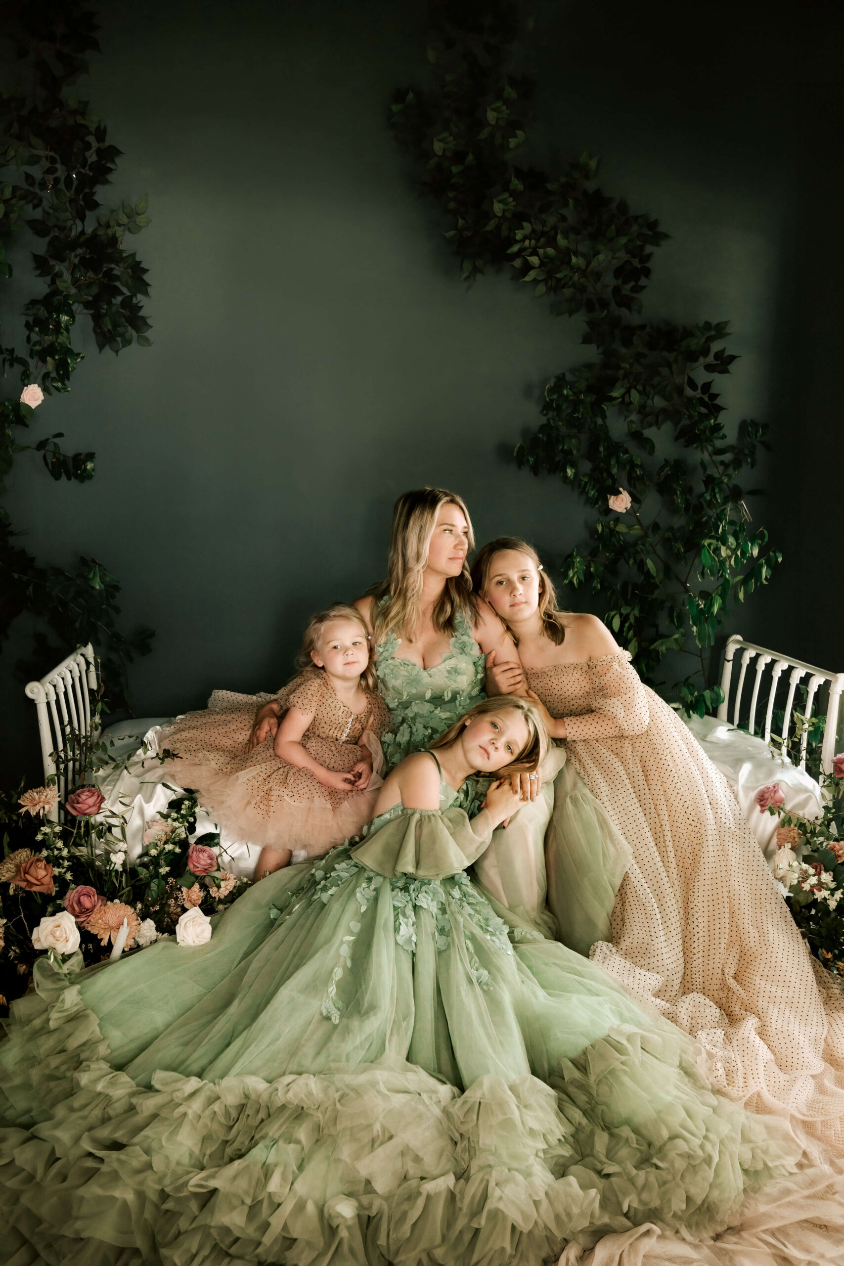 Gorgeous mom and three daughters wearing amazing couture dresses from Bentley and Lace in a studio in Conroe, TX.